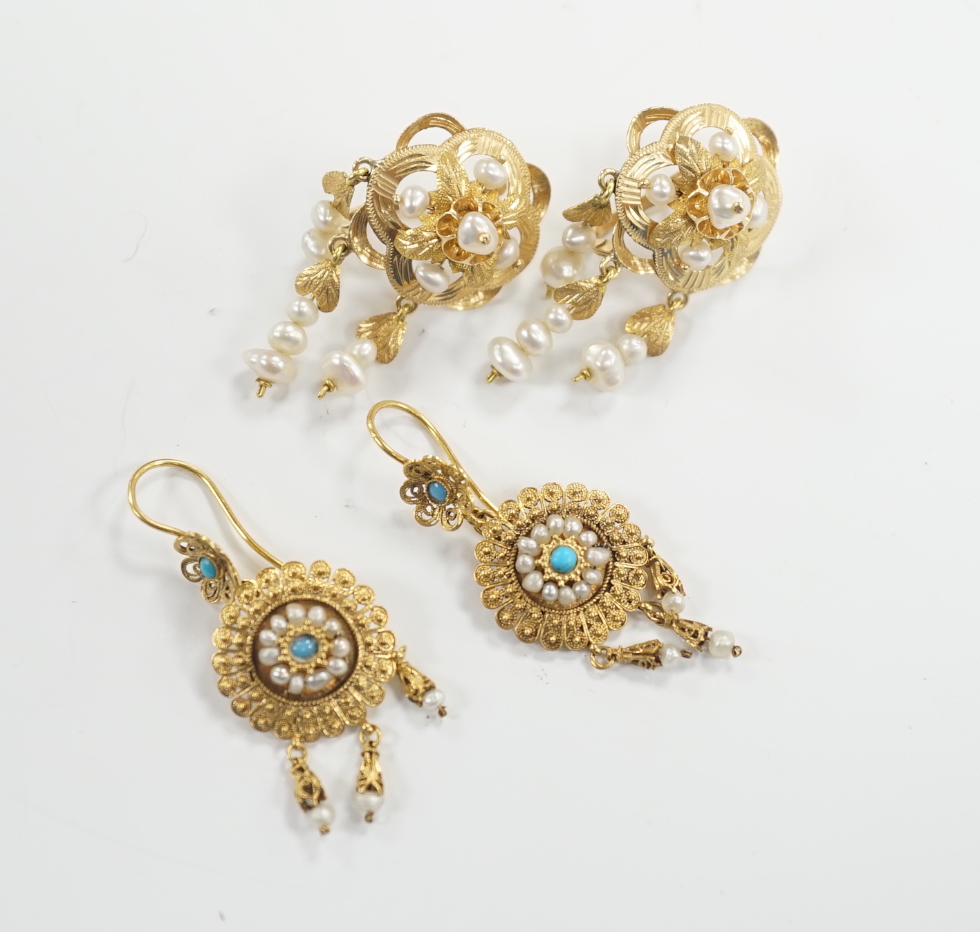 A pair of continental yellow metal and cultured pearl cluster set drop earrings, 36mm and a pair of yellow metal filigree, seed pearl and turquoise set drop earrings, gross weight 10.9 grams.